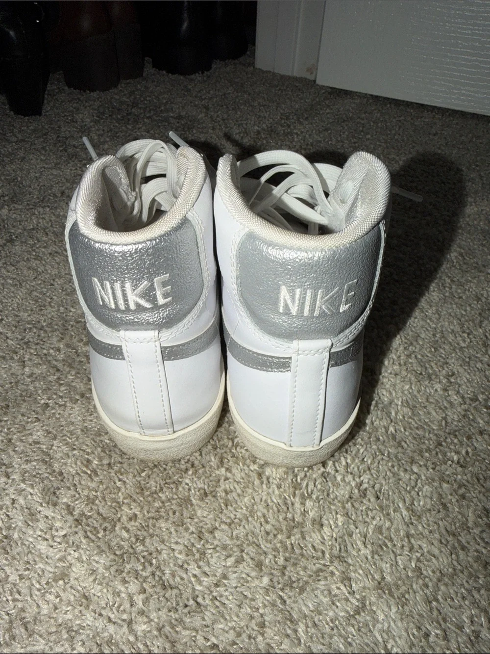 Nike White High-Top Sneakers with Silver Swoosh